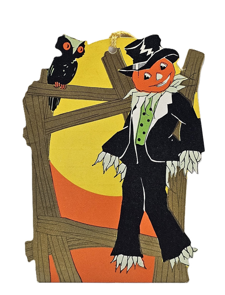 Halloween-themed decoration with a jack-o'-lantern in a suit and top hat, black cat, and wooden fence.
