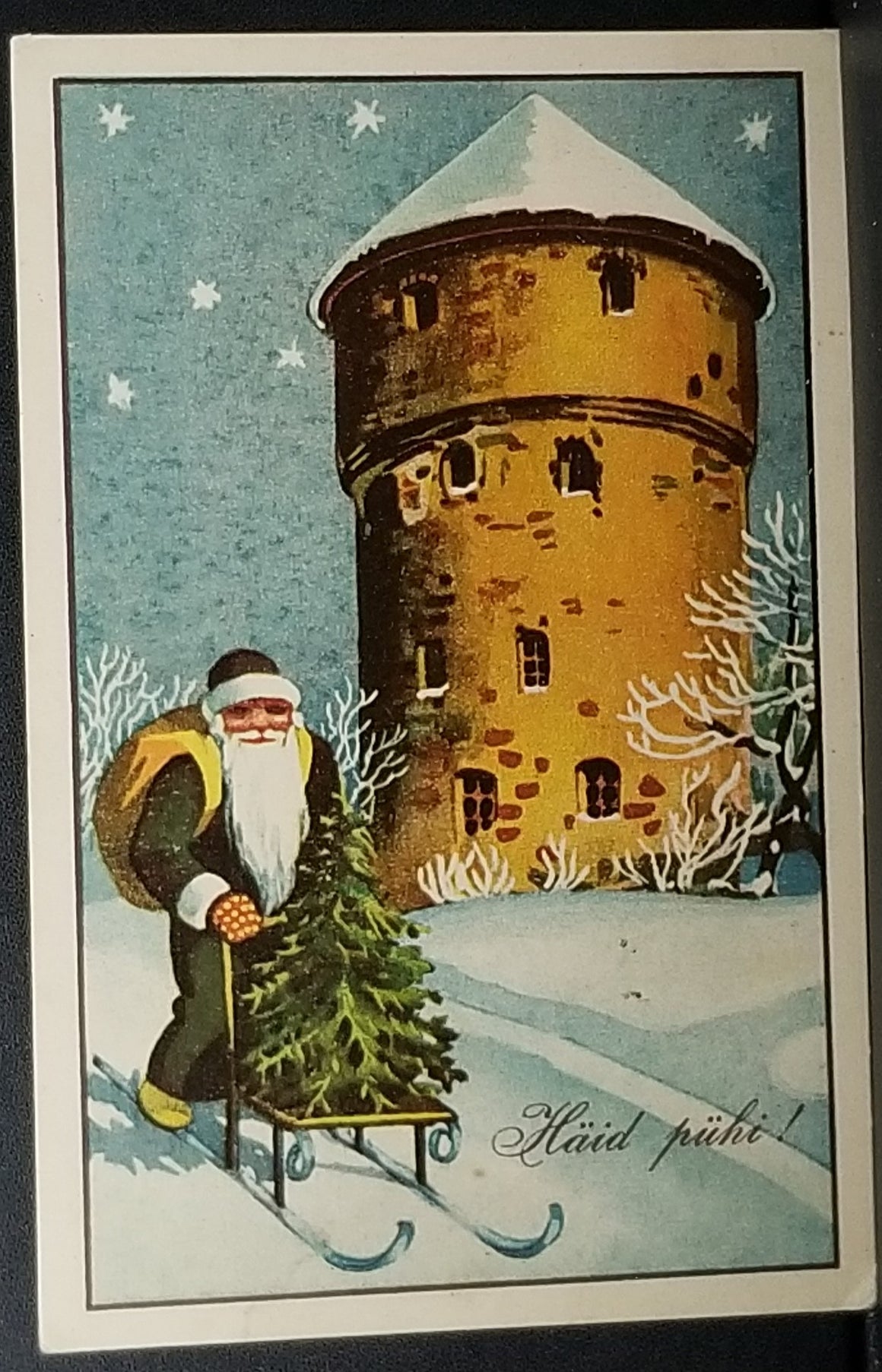 Christmas Postcard Finnish Santa Claus in Green Robe Pushing Tree on Sled