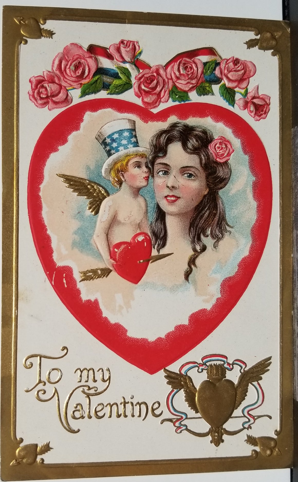Valentine Postcard Cupid in Uncles Sam Style Top Hat Kissing Woman Gold Embossed Series SB 260