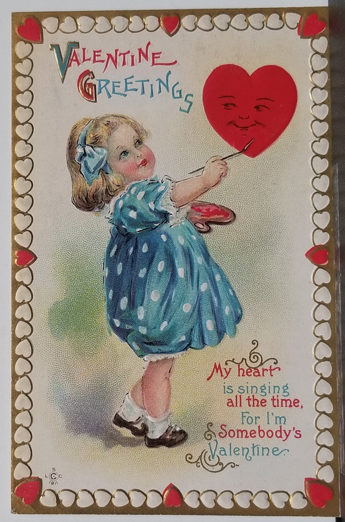 Valentine Postcard Little Girl in Blue Dress Painting a Face on Heart Gold Border Series 232