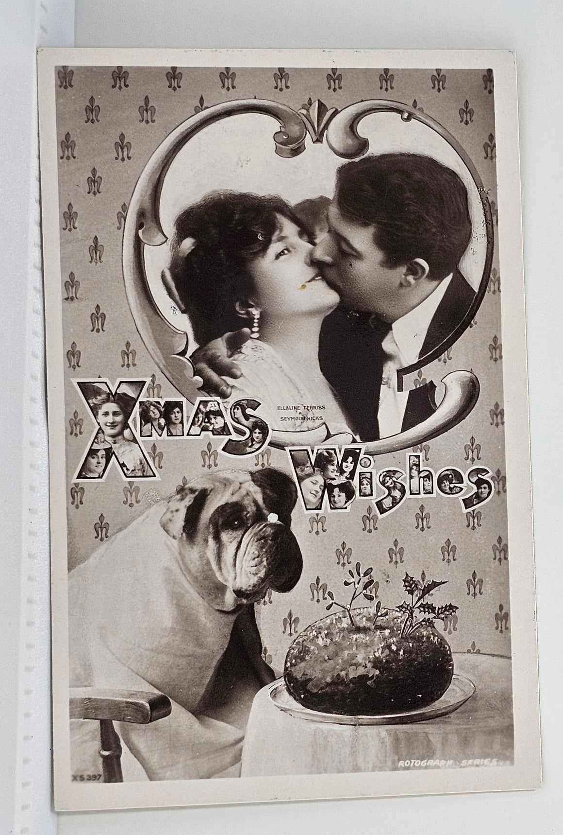 Christmas Postcard Real Photograph Young Couple Kissing and Bulldog Sitting at Table with Feast