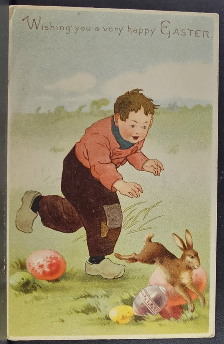 Easter Postcard Little Boy Chasing Bunny Rabbit in Field of Painted Eggs Gold Highlights
