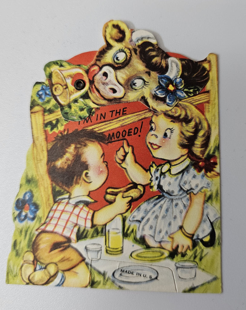 Vintage 1950s Mechanical Valentine Card Little Boy and Girl Having Picnic While Cow with Bell Peeks Over