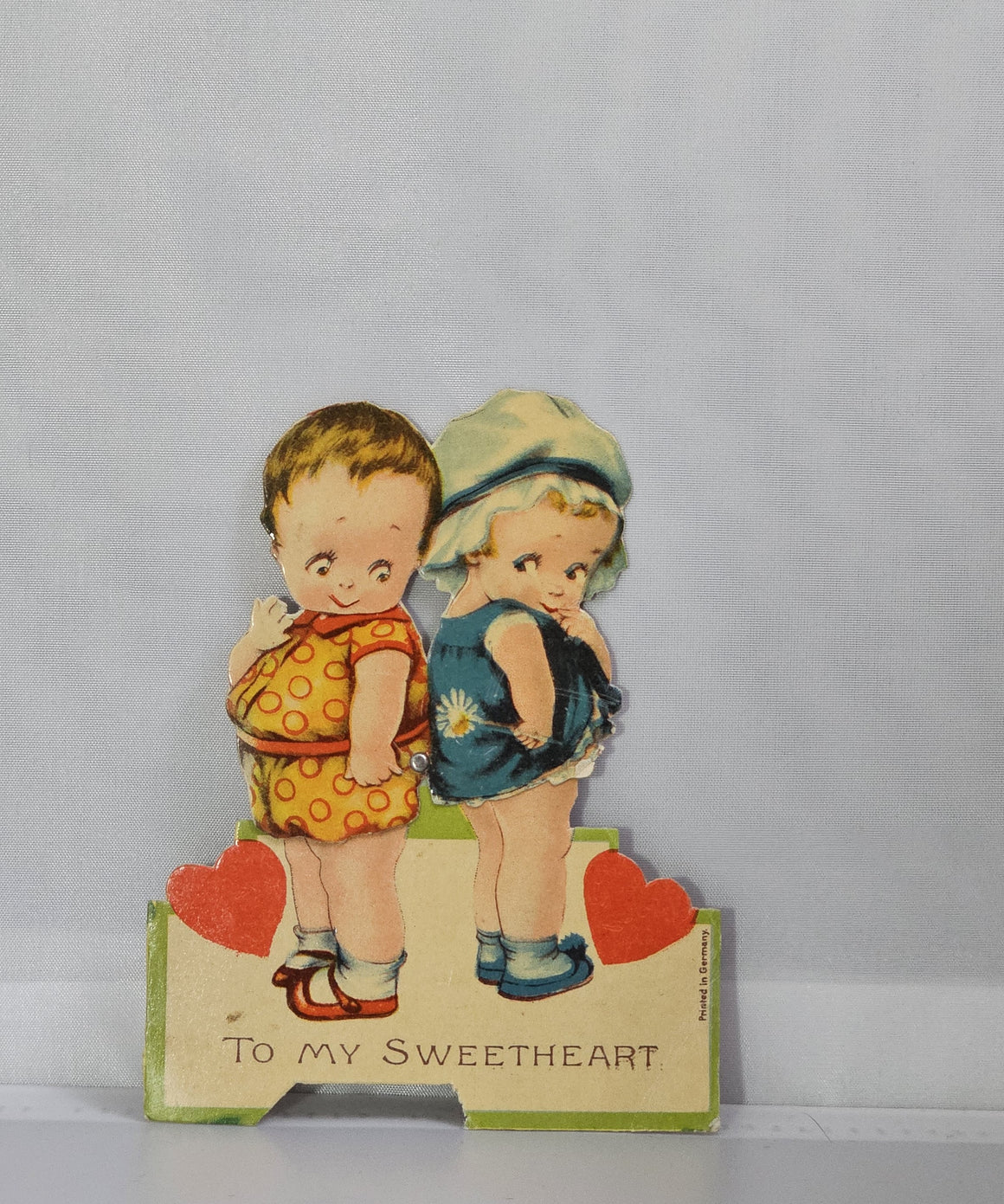 Vintage Mechanical Die Cut Valentine Card Little Boy and Girl Standing Back to Back with Hearts & Flowers Made in Germany