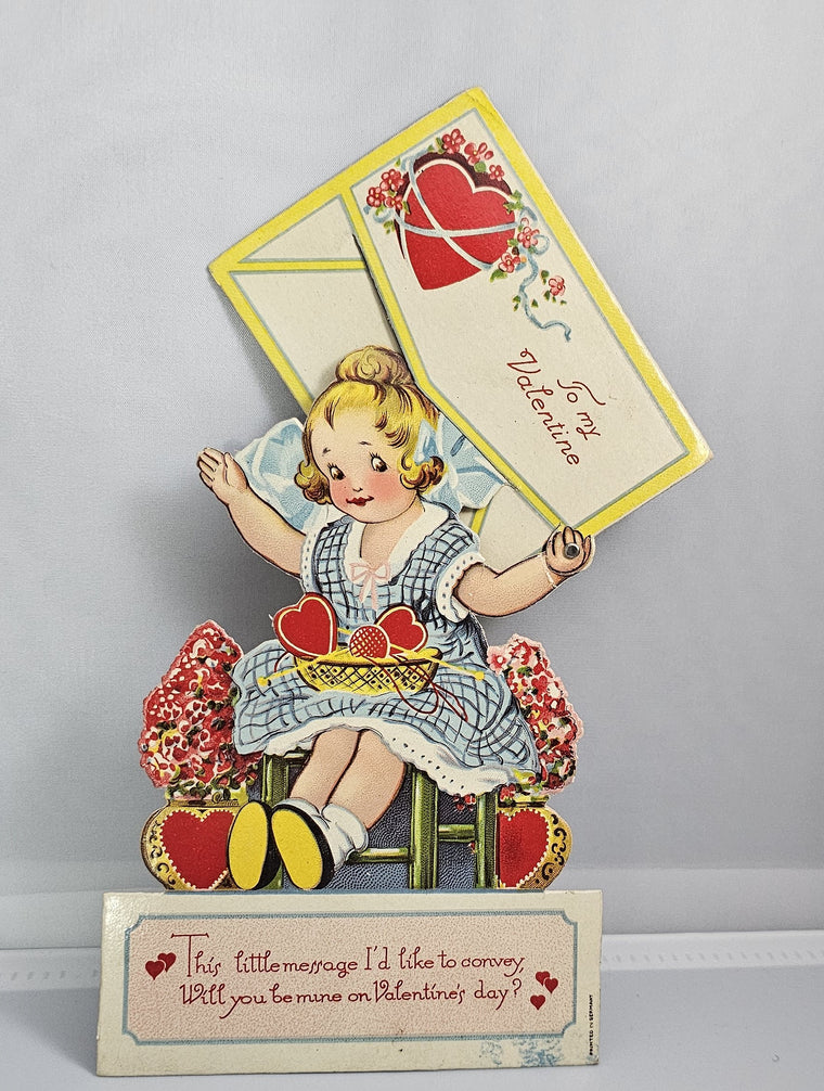 Vintage Die Cut Mechanical Valentine Little Girl in Blue Dress with Hearts & Flowers Hiding in Giant Envelope