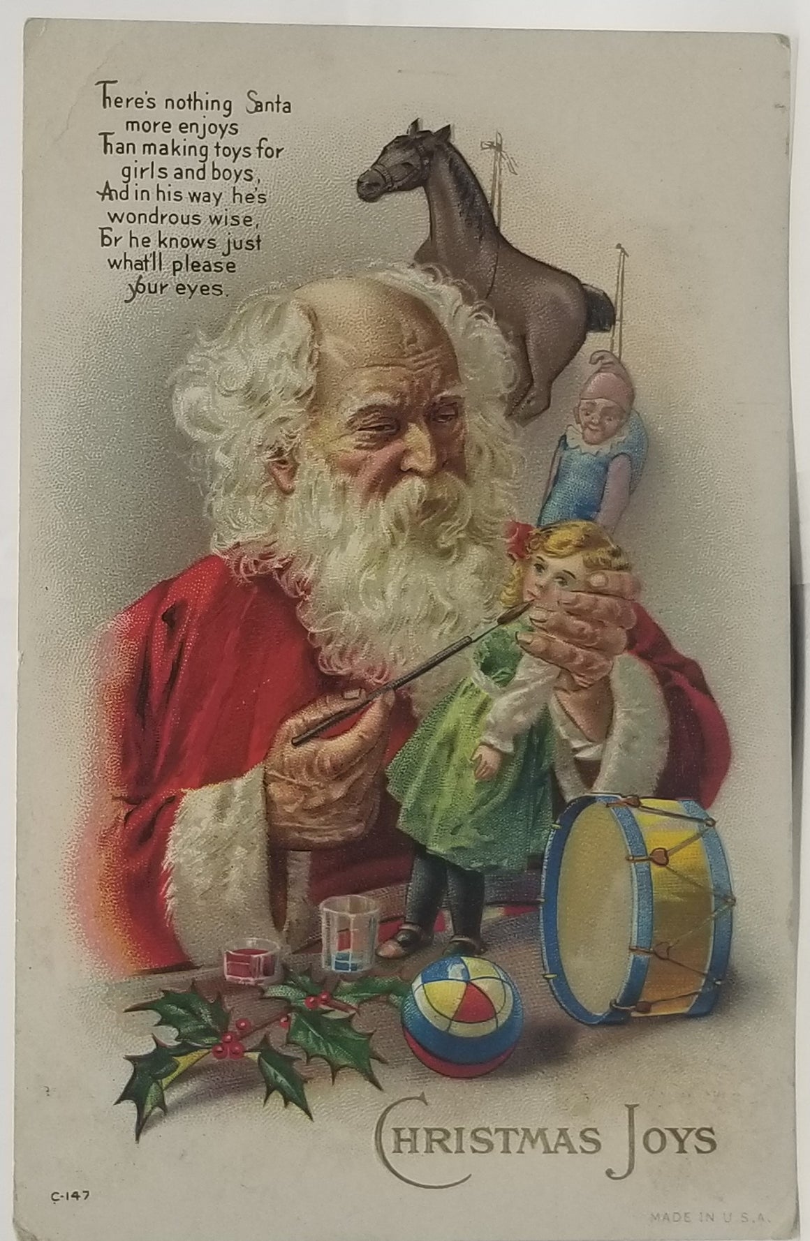 Christmas Postcard Santa Claus Surrounded By Toys Painting a Doll