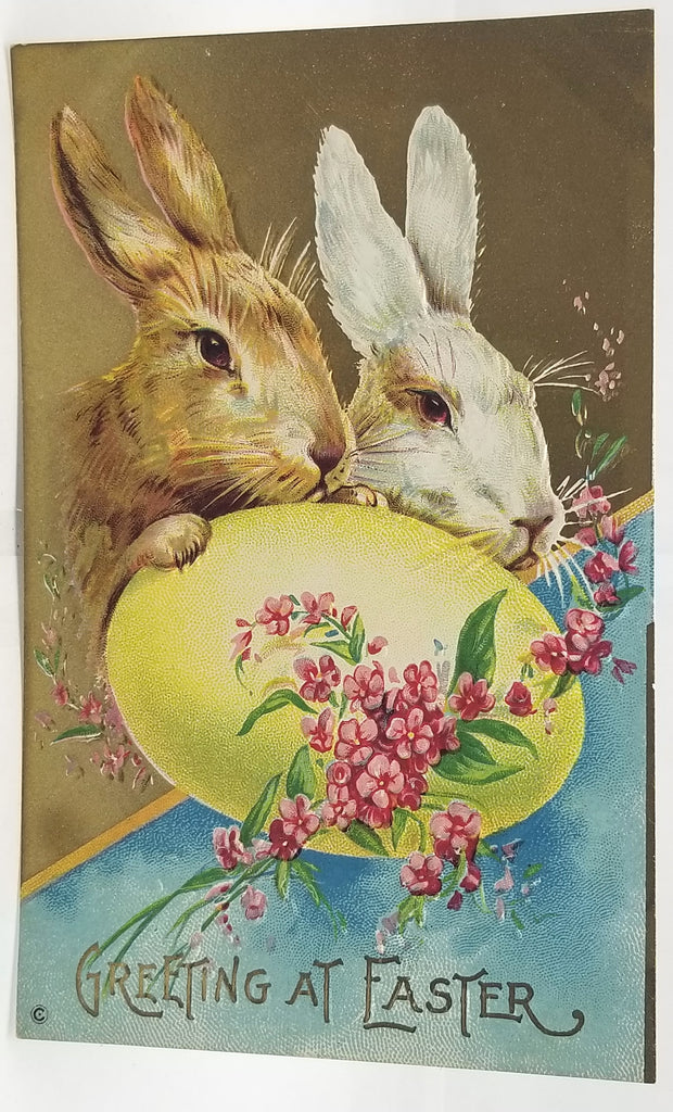Vintage-style Easter card with two rabbits and a large egg, featuring flowers and text.