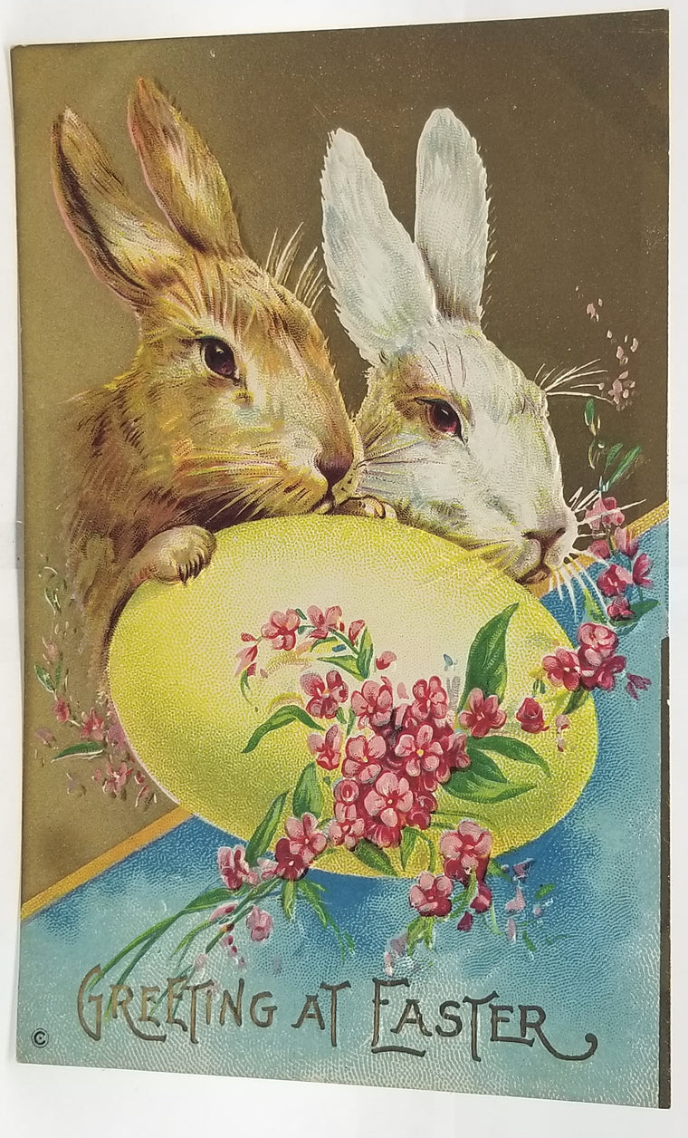 Vintage-style Easter card with two rabbits and a large egg, featuring flowers and text.