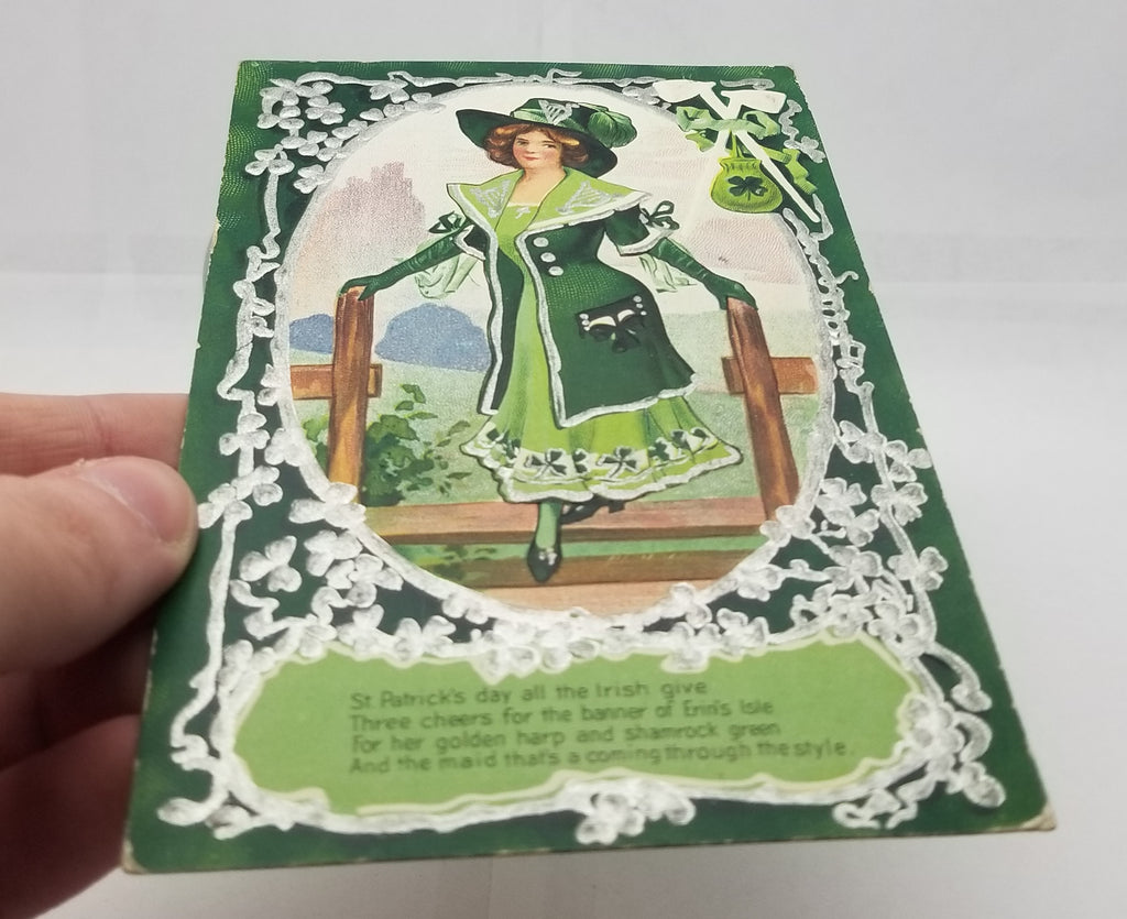 St Patrick's Day Postcard Silver Embossed Card Irish Woman in Green White Pipes Pot of Gold in Corner No 3