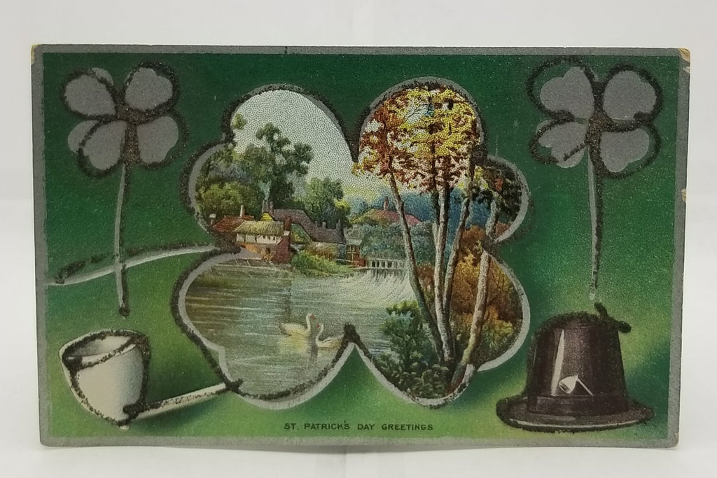 St Patrick's Day Postcard Silver Embossed Card Applied Glitter Landscape Scene with Pond in Ireland Pipe & Shamrocks