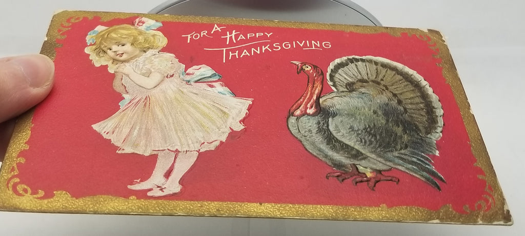 Thanksgiving Postcard Little Girl with Patriotic Ribbons Standing with Turkey Red Background Gold Border