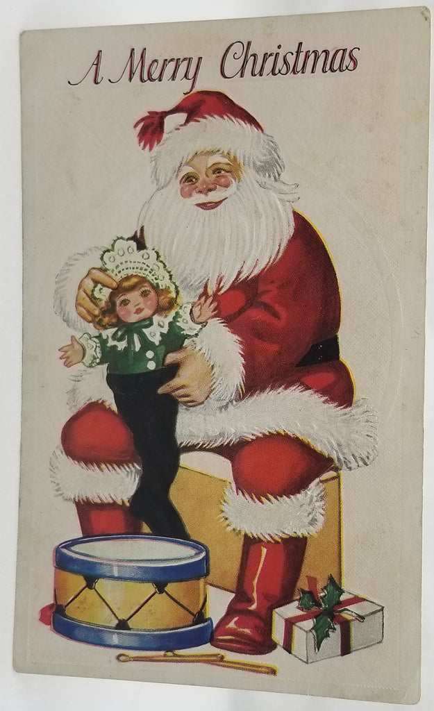 Christmas Postcard Santa Claus Slipping Doll Into Stocking with Drum Kit at Feet Series C-49