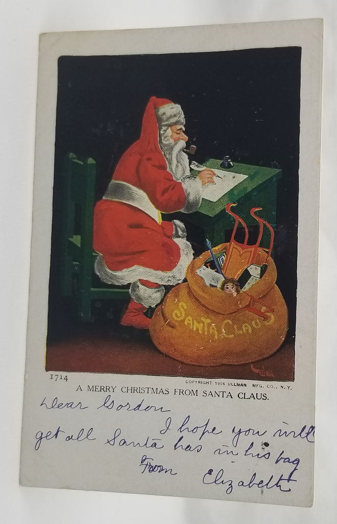 Christmas Postcard Santa Claus Smoking Pipe Reviewing Naughty Nice List with Bag of Toys at Feet Ullman 1909