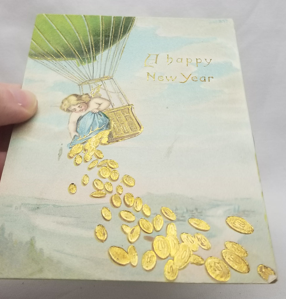 New Year's Postcard, Vintage Post Card of Cherub Angel Dropping Gold Coins From Air Balloon Gel Like Finish