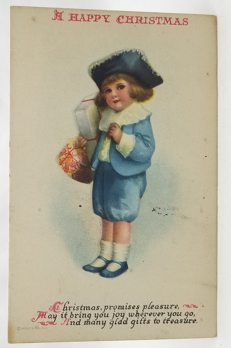 Christmas Postcard Child in Blue Holding Gifts Artist Clapsaddle