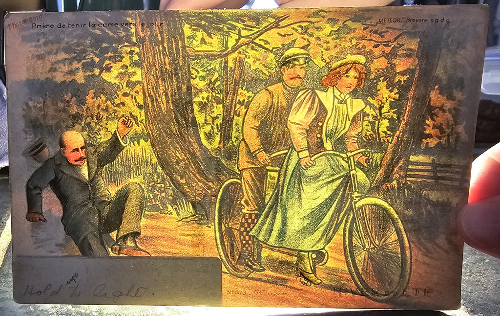 Antique Novelty Hold To Light Postcard, German HTL Card with Ice Skating Couple in Snow Light Changes Card to Couple Riding Bike in Forest