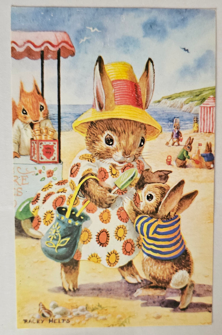 Illustration of bunnies at a beach with a child and a beach umbrella.