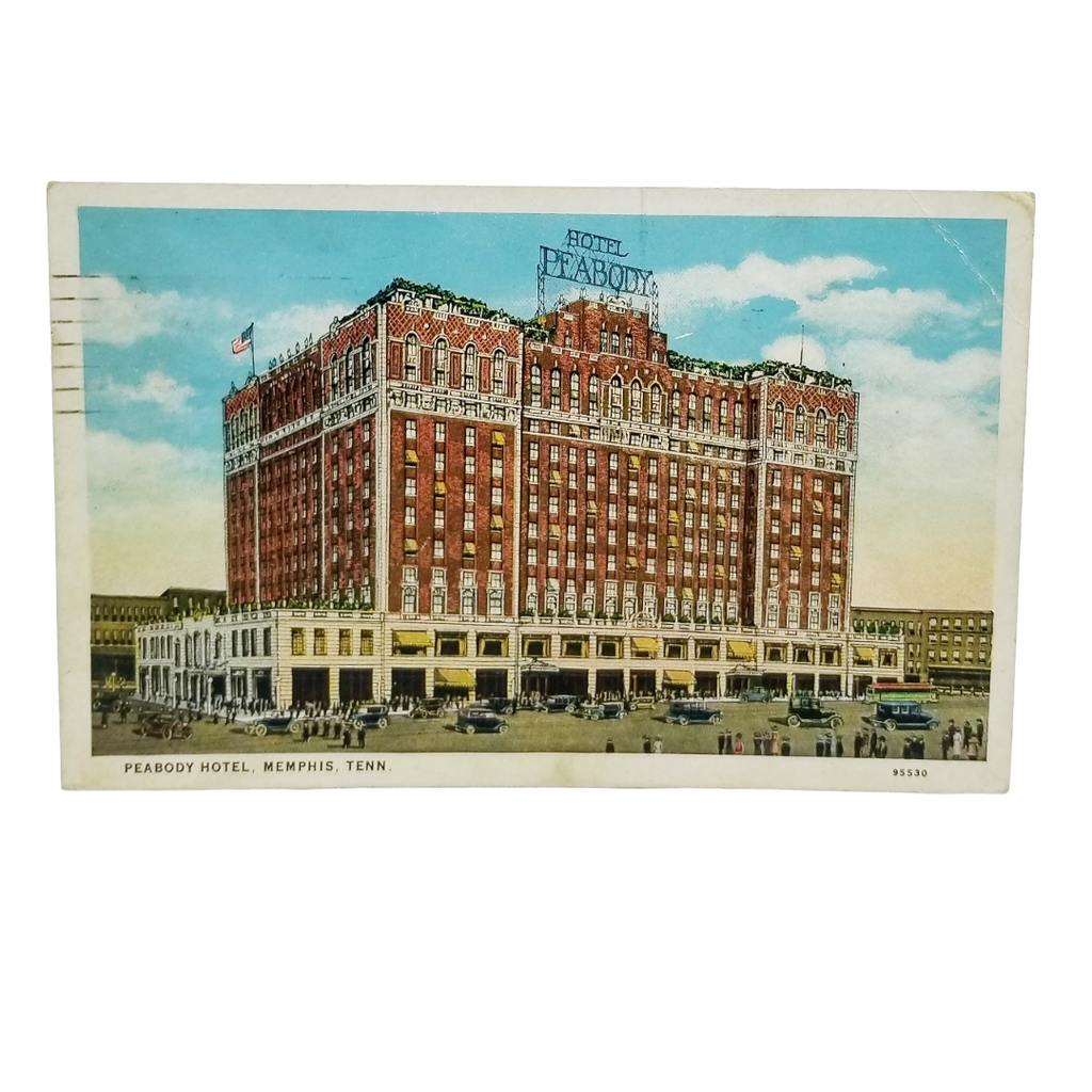 A vintage postcard showing the historic Peabody Hotel in Memphis, Tennessee. The postcard features a detailed illustration of the red brick hotel with white trim, a blue sky with clouds, and small figures of people and cars at the base.