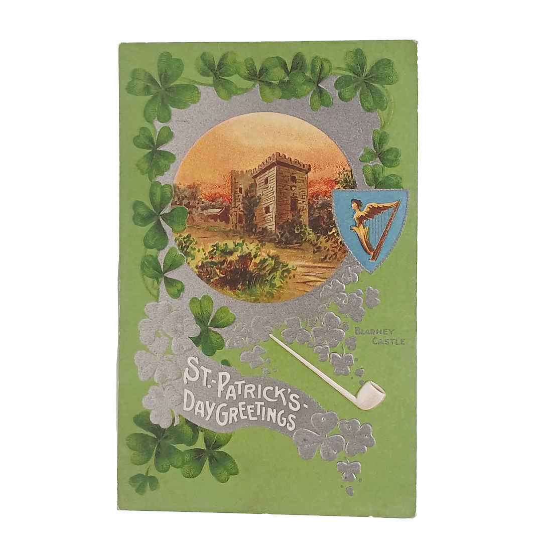 Vintage St. Patrick's Day greeting card with clovers, castle illustration, and smoking pipe.