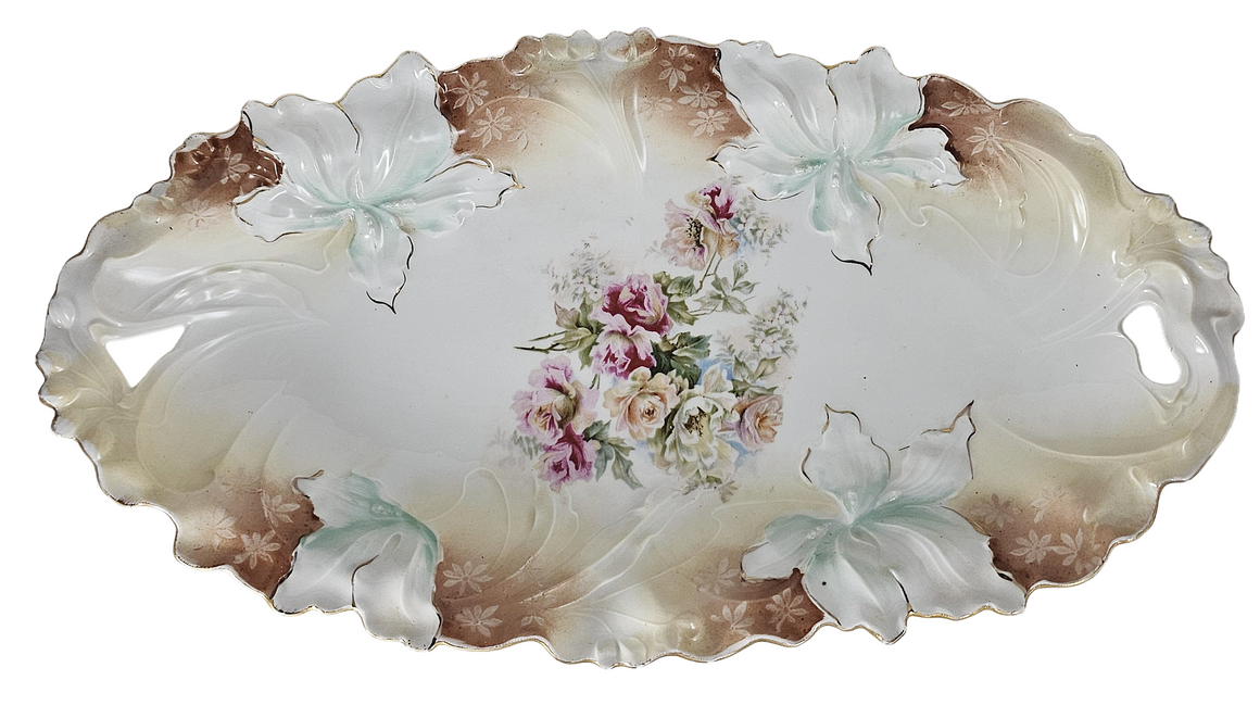 Decorative ceramic plate with floral design and leaf patterns on a white background