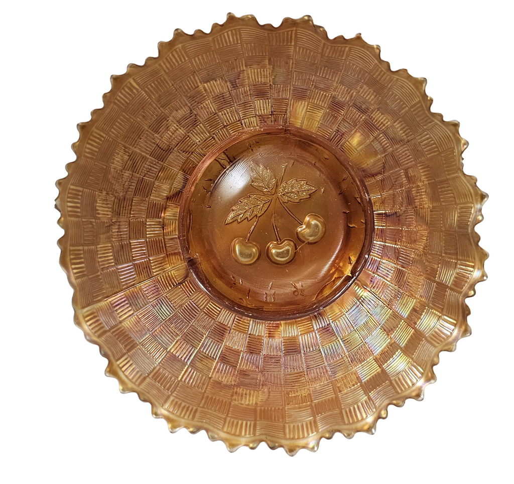 Decorative glass dish with leaf and berry design on a white background