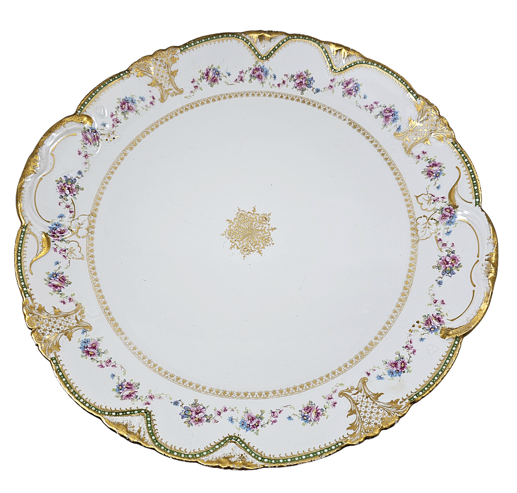 Decorative plate with floral and gold detailing on a white background