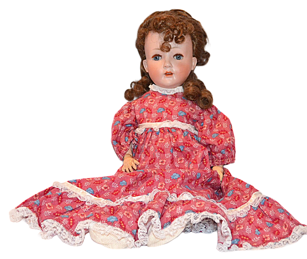Vintage doll in a red floral dress on a white background