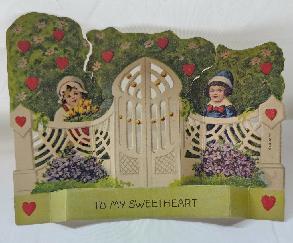 Vintage Antique Die Cut Mechanical German Valentine Card Children Behind Gate with Doors in Apple Orchard Card Opens at Doors