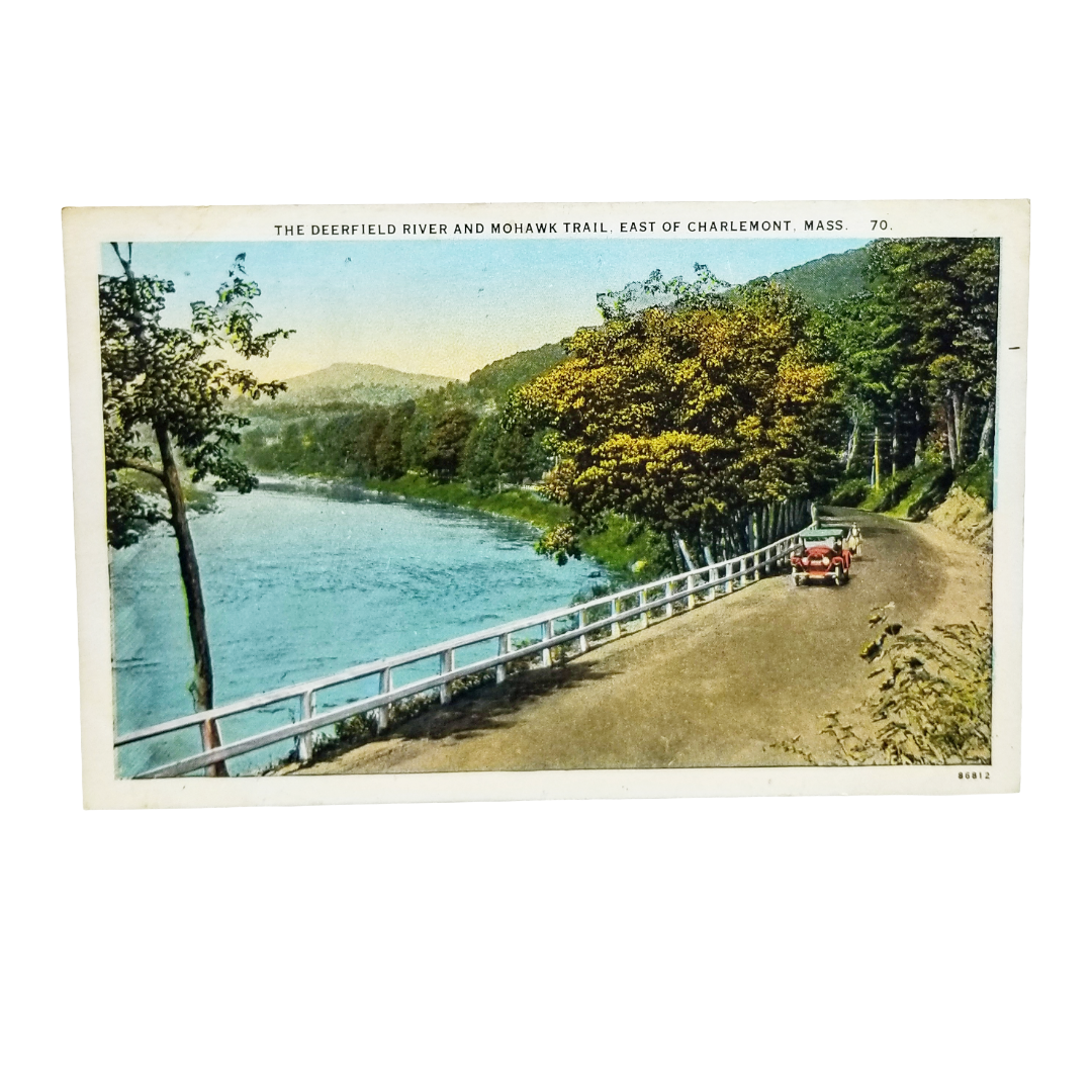 A vintage postcard showing the Deerfield River and Mohawk Trail in East of Charlemont, Mass., with a winding road, trees, a river, and two early 20th-century cars on the trail.