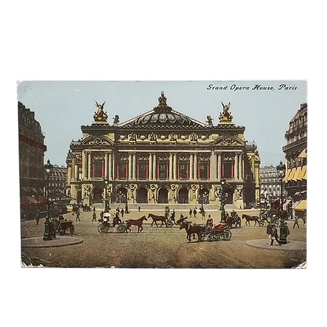 A vintage postcard depicting the Grand Opera House in Paris, with horse-drawn carriages and pedestrians in the foreground. The postcard is shown against a plain white background.