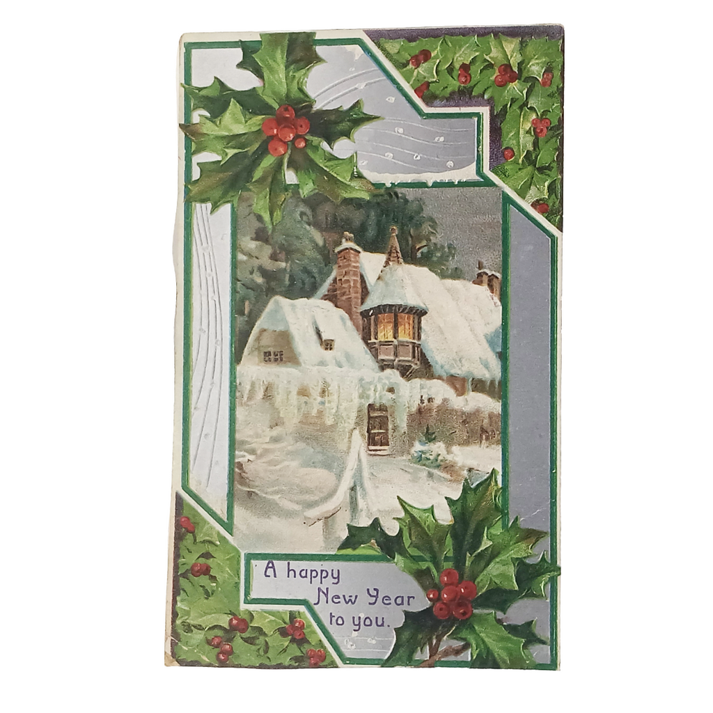 Vintage-style Christmas card with a snowy village scene and holly leaves.
