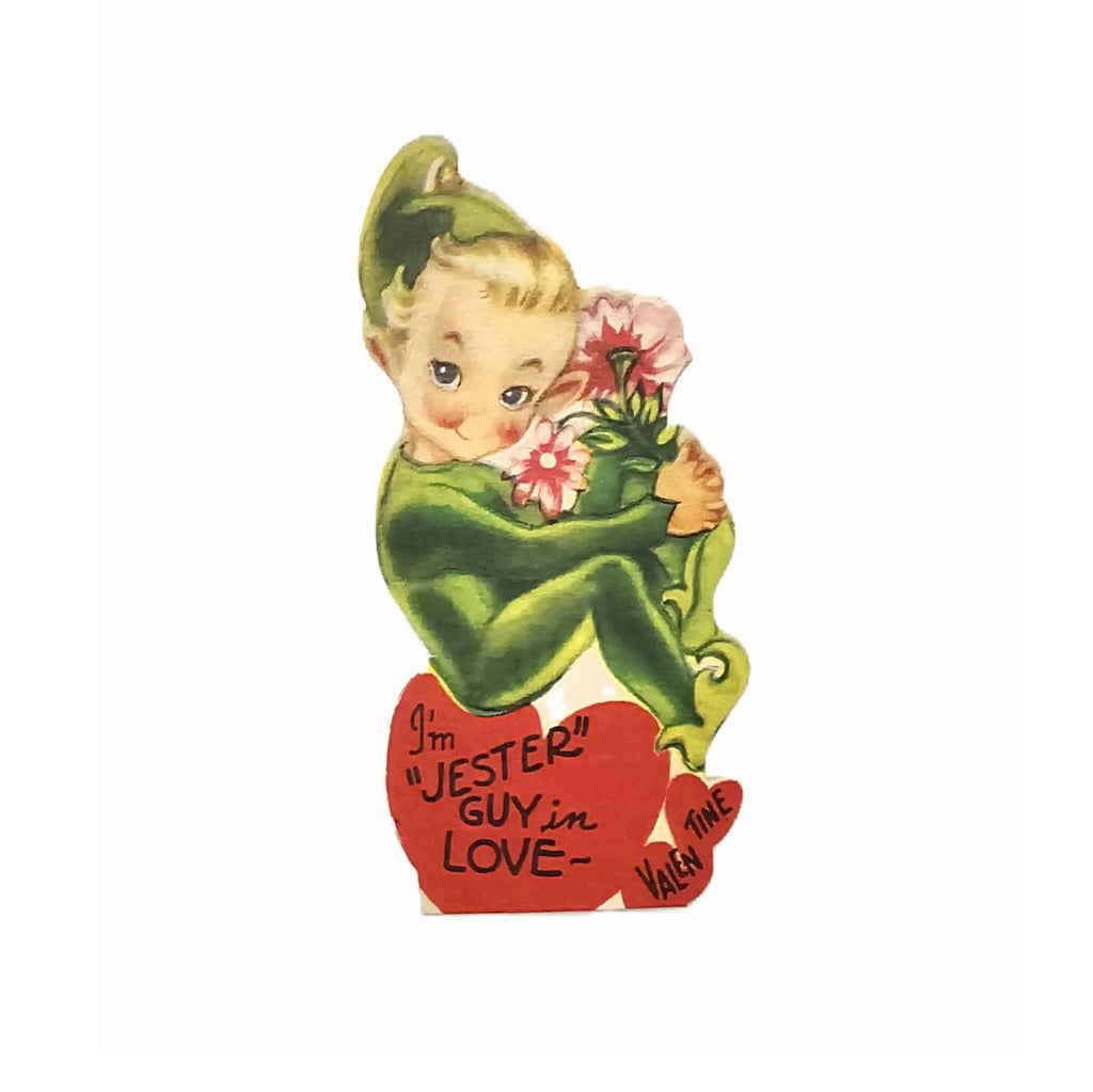 Vintage Die Cut Valentine Card Little Jester Elf in Green Atop a Heart Holding Flowers