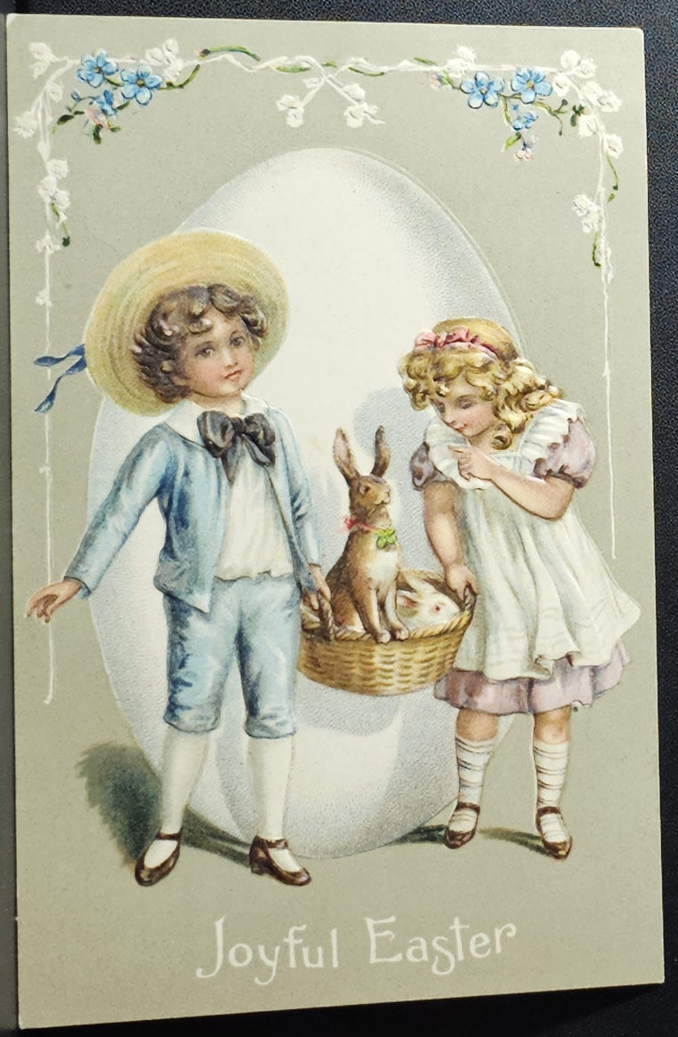 Easter Postcard Children Carrying Bunny Rabbits in Basket with Giant Embossed Egg In Background