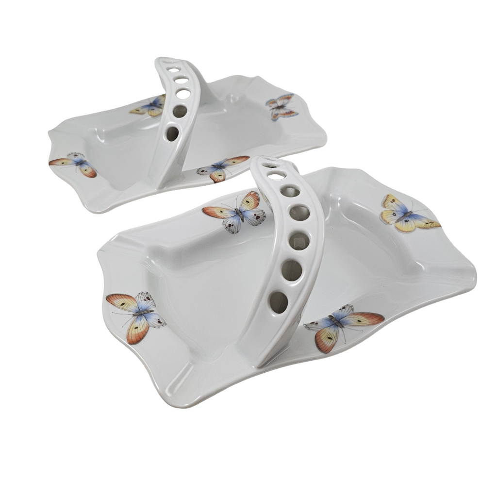 Two white ceramic butterfly-patterned dishes on a white background