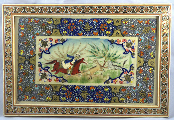 Decorative painting with horses and riders in a decorative frame