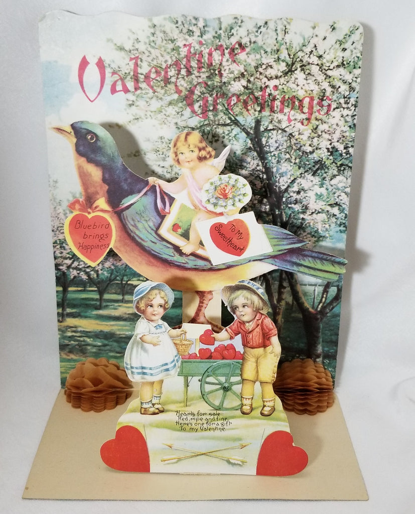 Large Vintage Antique Valentine Card Embossed with Fold Down 3D Cupid Riding Giant Blue Bird Children Trading Hearts From Wagon Germany