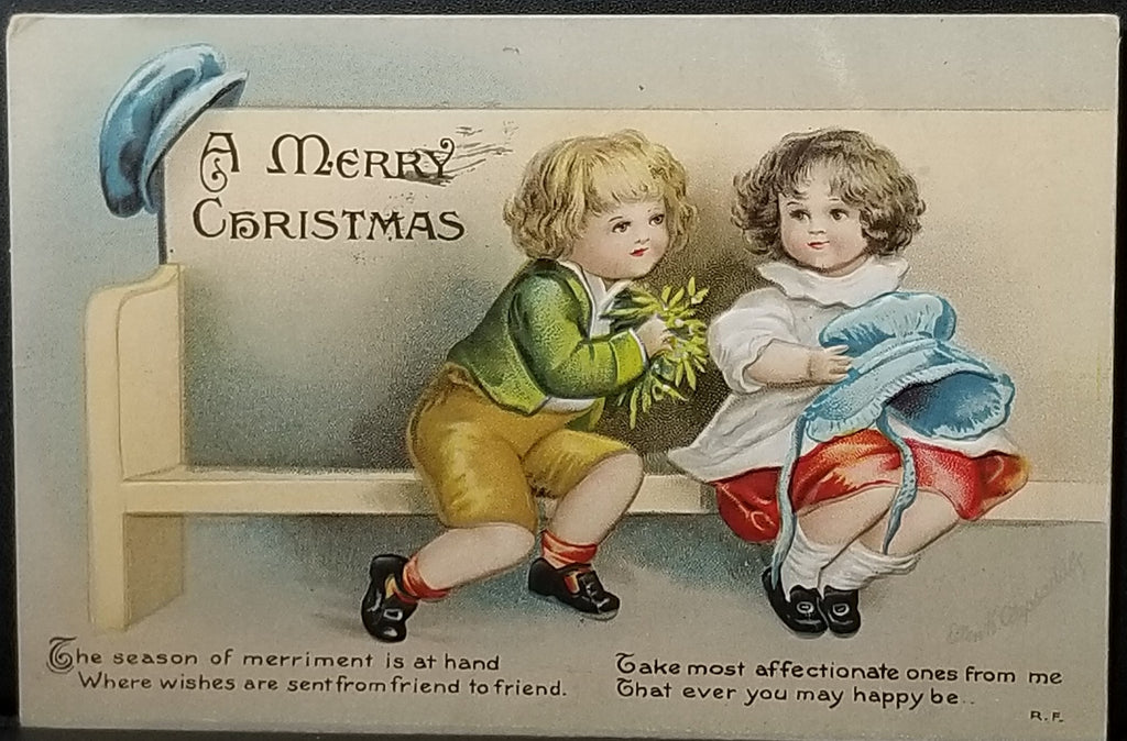 Christmas Postcard Children on Bench Boy Offering Mistletoe Artist Ellen Clapsaddle IAP Publishing