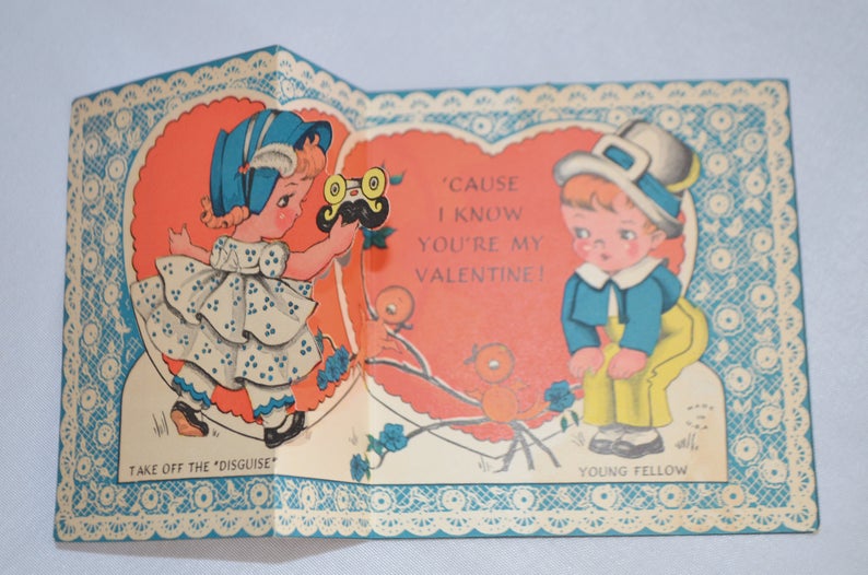 Antique Valentine's Day Card Fold Open Embossed Image Little Girl Removing Boy's Mask Pretty Heart Background Blue Floral Border