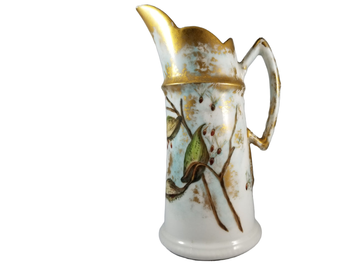 A French Limoges porcelain tankard jug pitcher with hand painted thistle decoration and gold highlights.